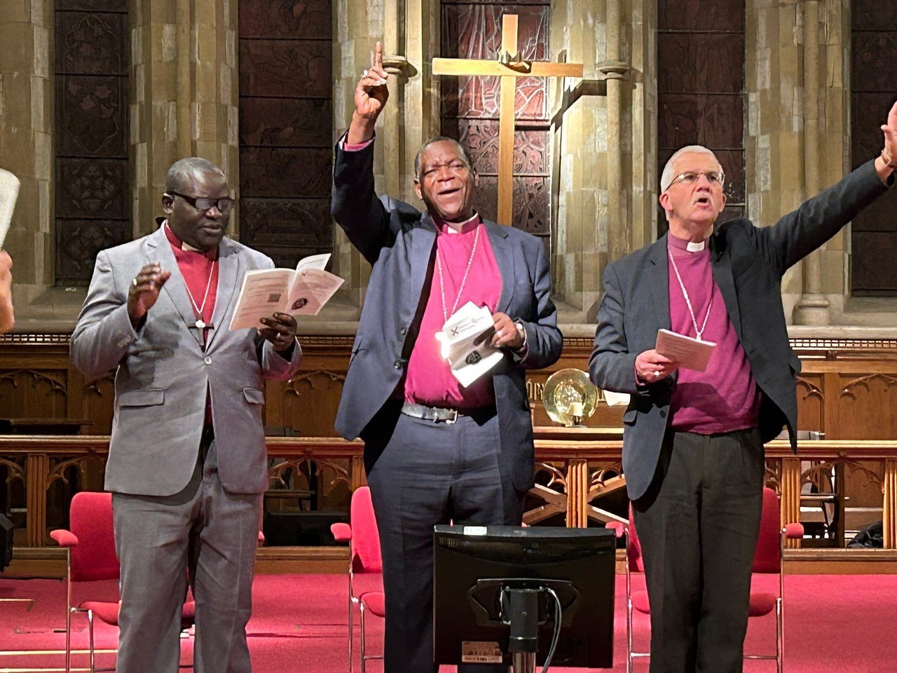 Bishop Jonathan presents Bishop Luzineth and his wife with the gift of a cross at the new Bishop's consecration