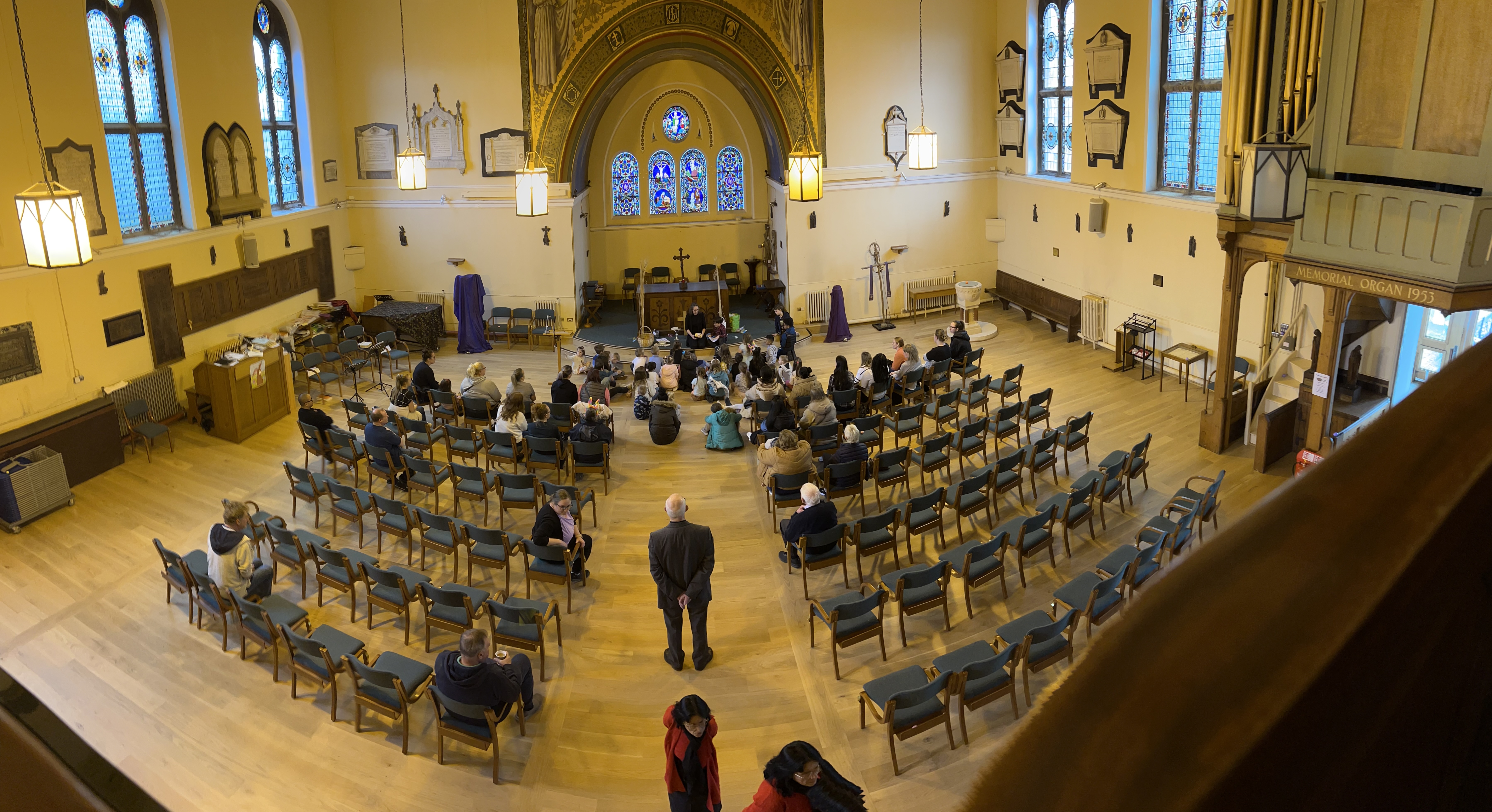 Overhead view of the church with people sat on floor and chairs