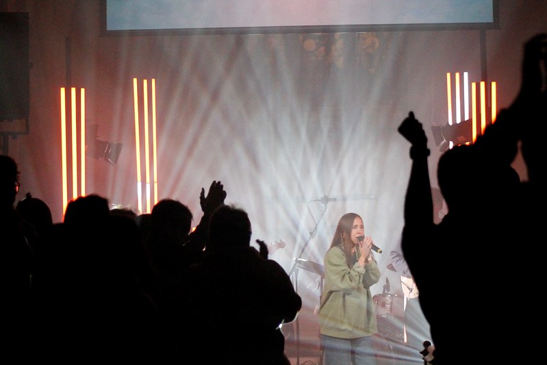 Ellie Limbear can be seen through the silhouetted crowd of young people